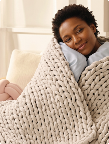 Woman smiling under weighted blanket