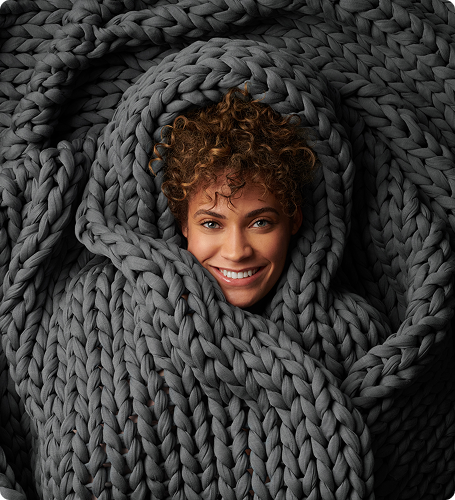 Woman wrapped in grey blanket