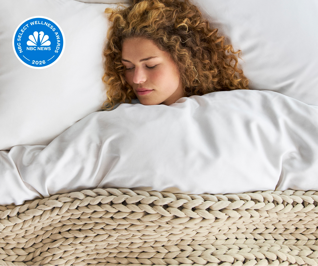 Woman sleeping under weighted blanket